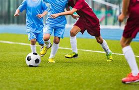 Young players practicing football in a local stadium.