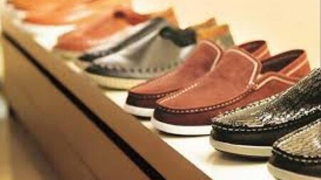 A worker inspects leather footwear in a Pakistani factory as exports surge in FY25.