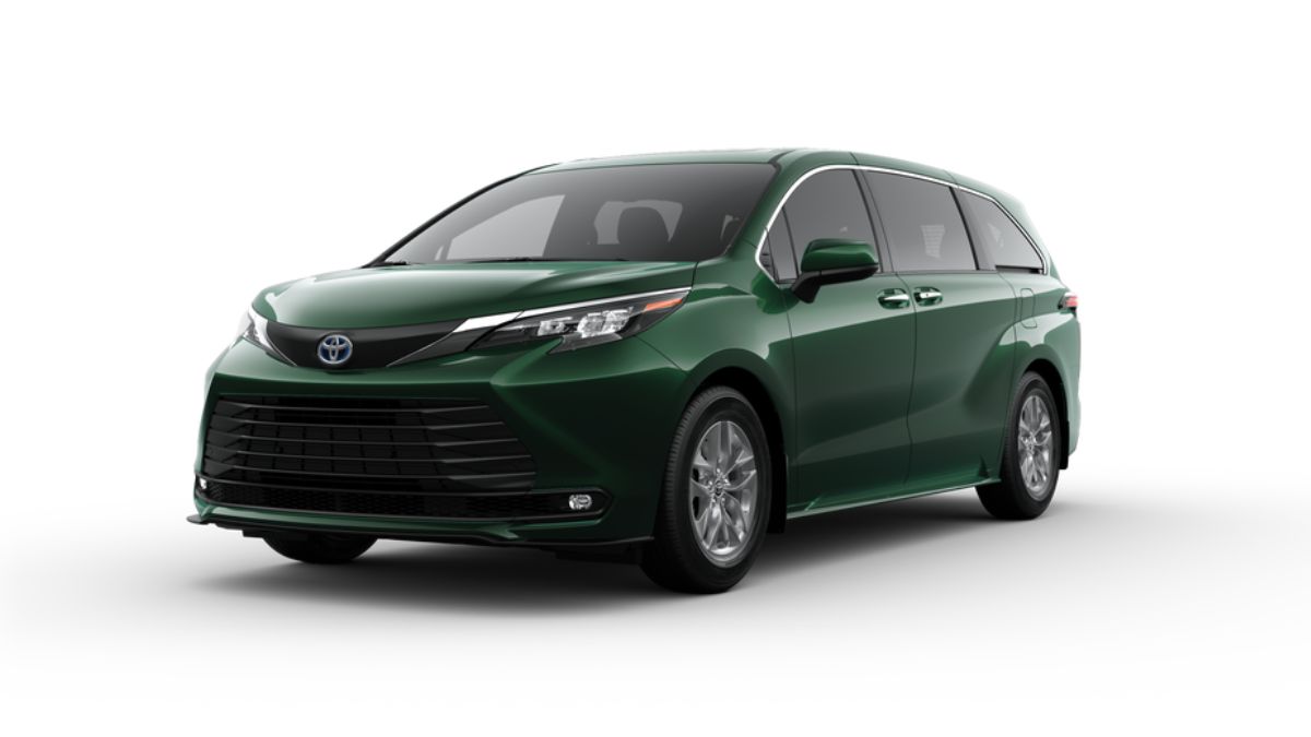 Red 2025 Toyota Sienna hybrid minivan parked with a scenic background