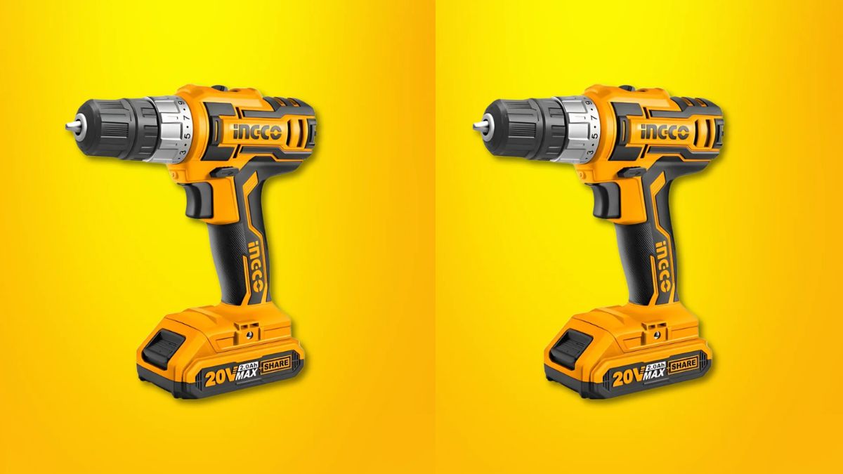 Cordless charging drill machine with battery and drill bits on a wooden surface