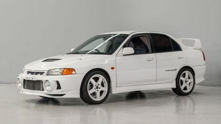 Mitsubishi Lancer 1997 vintage car parked on city street in Pakistan