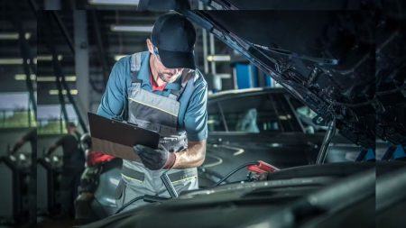 Mechanic inspecting a car engine during a car inspection in 2025