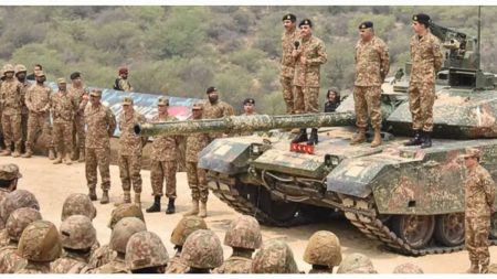 Pakistani military personnel stand guard, representing the armed forces' dedication.