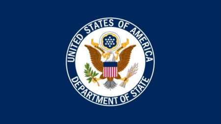 U.S. State Department seal with American flag and breaking news headline