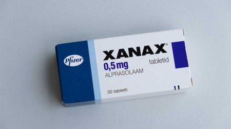 Xanax tablet pack placed on a table with a doctor's prescription
