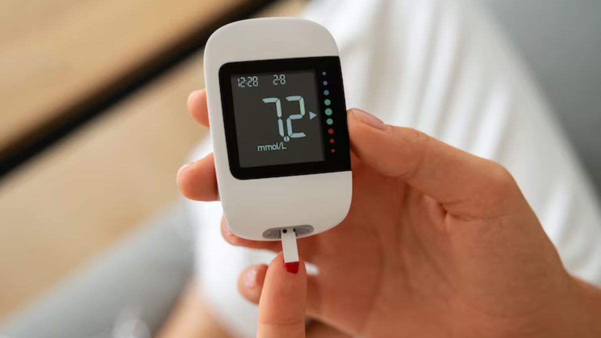 Person checking blood sugar at home using a glucometer