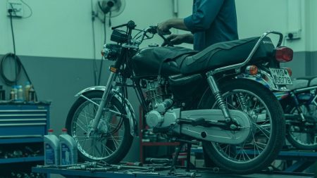 Motorcycle servicing in Karachi with mechanic tuning bike in workshop