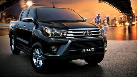 Toyota Hilux Revo 2018 parked in Pakistan city street – Front and side view