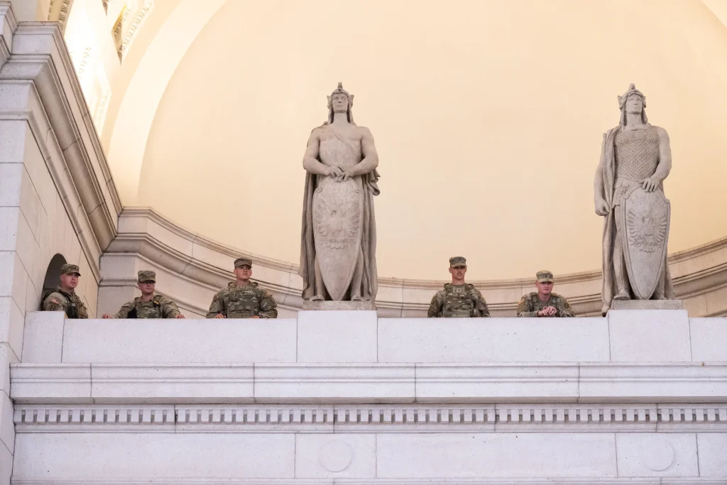 Members of the National Guard stand guard while US Vice President and JD Vance, Defense Secretary Pete Hegseth and White House Deputy Chief of Staff Stephen Miller (not pictured) meet with members of the National Guard stationed at Union Station in Washington, DC, on August 20, 2025.
